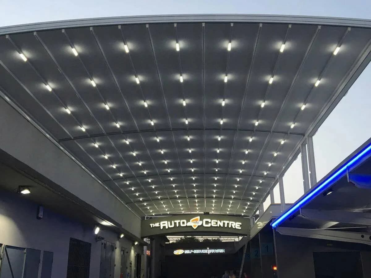 Spacious enclosed terrace with glass walls and pergola roof