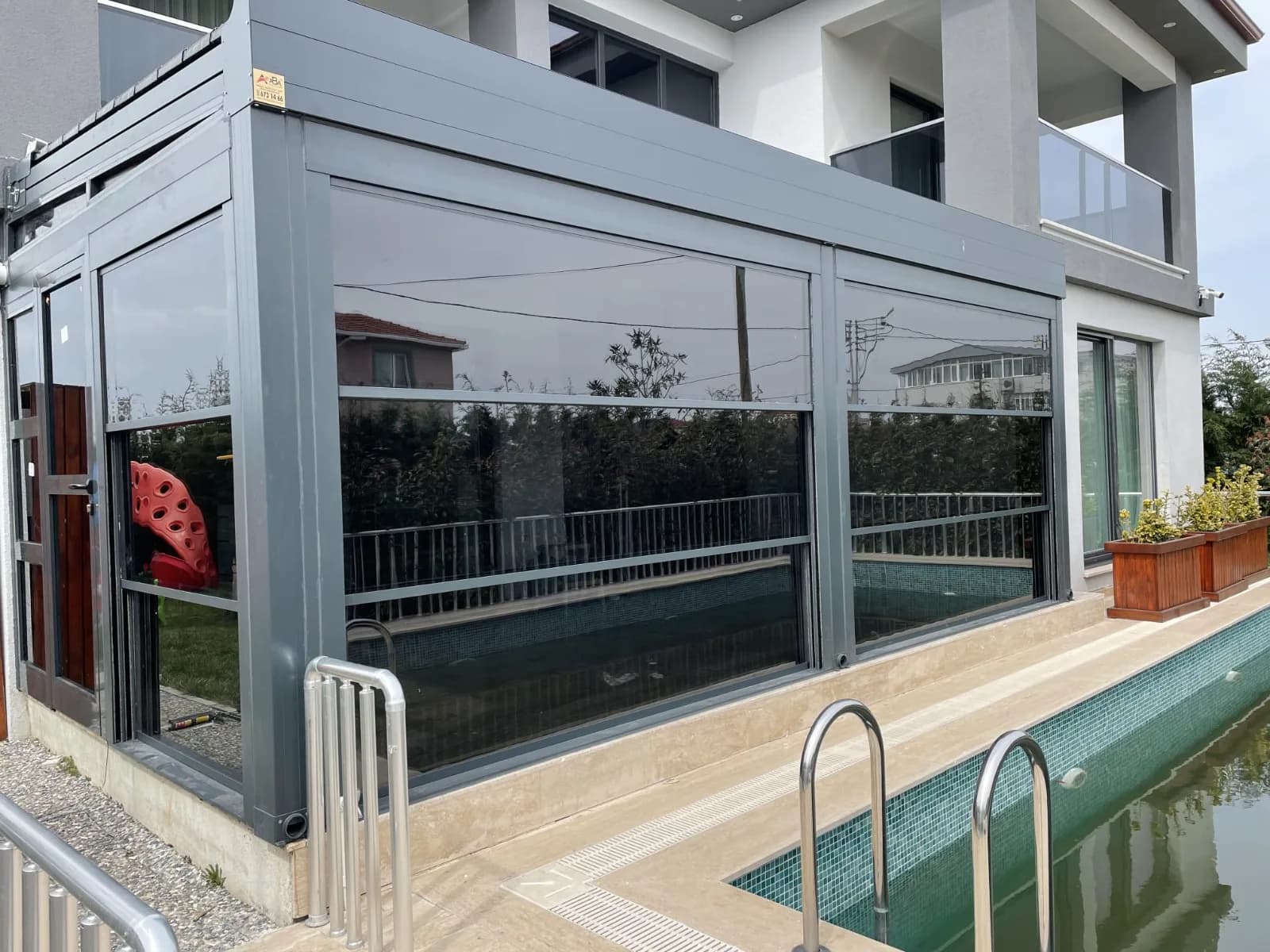 Modern pergola over outdoor pool with elegant dark structure